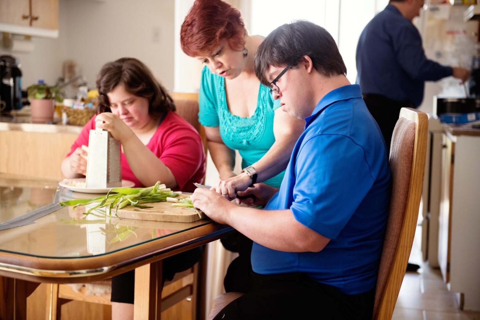 A group of people sitting at a table with food.
